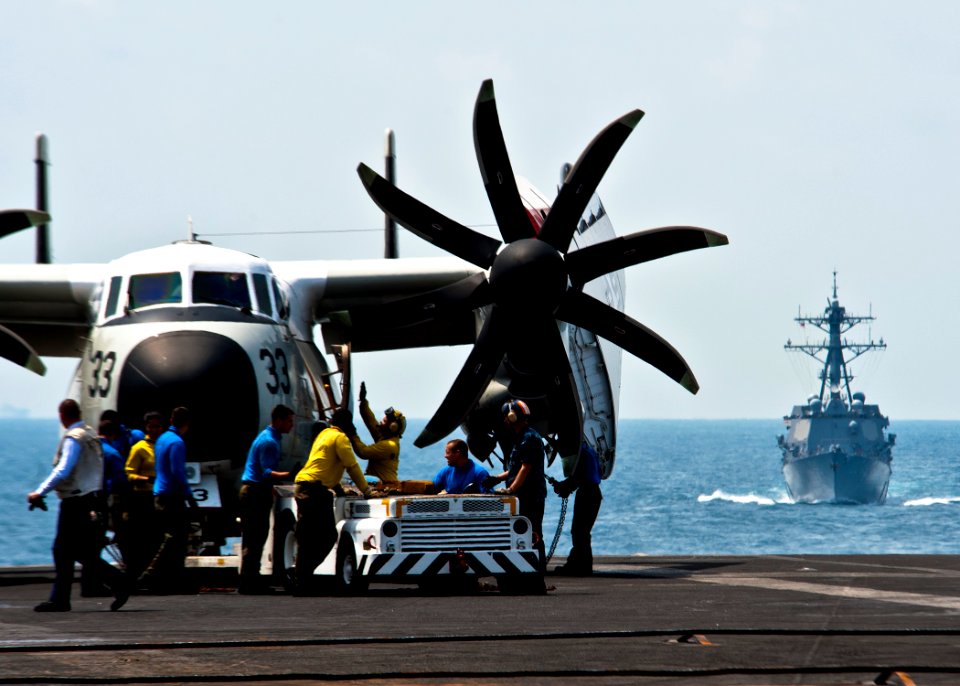 US Navy 120130-N-BT887-353 Sailors prepare to move a C-2A Greyhound from the Providers of Fleet Logistics Combat Support Squadron (VRC) 30 aboard t