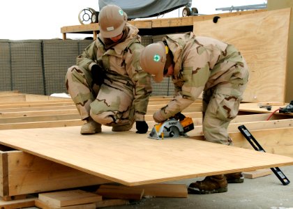 US Navy 120202-N-SD610-003 A Sailor operates a circular saw during the construction of a wood deck for an Alaska tent photo