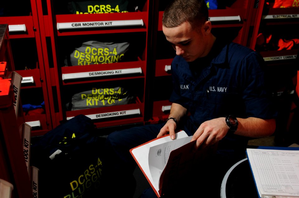 US Navy 120202-N-GZ832-025 Damage Controlman Fireman Cameron Michalak inventories a pipe patching kit in a repair locker aboard the Nimitz-class ai