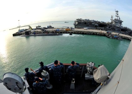 US Navy 120130-N-ED900-221 Cmdr. Benjamin Nicholson, executive officer aboard the guided-missile destroyer USS Pinckney (DDG 91), renders honors wh