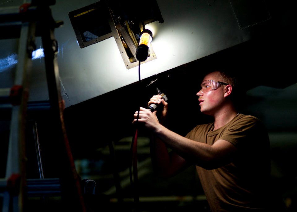 US Navy 120204-N-BT887-069 Aviation Electrician's Mate 3rd Class John Jost repairs the ramp of a C-2A Greyhound from the