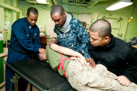 US Navy 120130-N-PB383-053 A Sailor checks for secondary wounds on a simulated casualty