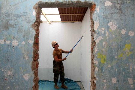 US Navy 120201-A-IP644-082 A Sailor re-paints a wall during a service project in Zona De Acapulco