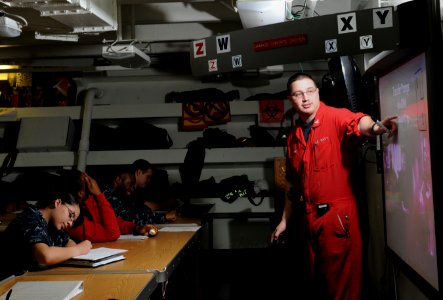 US Navy 120202-N-GZ832-012 Damage Controlman 3rd Class Joseph Maciejewski teaches an advanced damage control class aboard the Nimitz-class aircraft