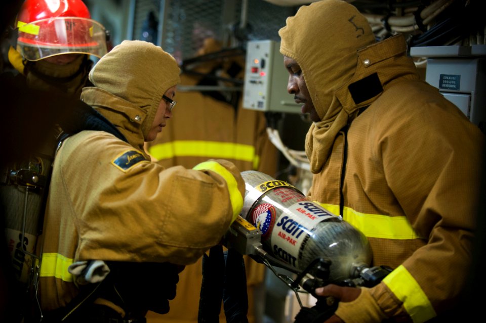 US Navy 120130-N-PB383-224 A Sailor explains how to a don a self-contained breathing apparatus