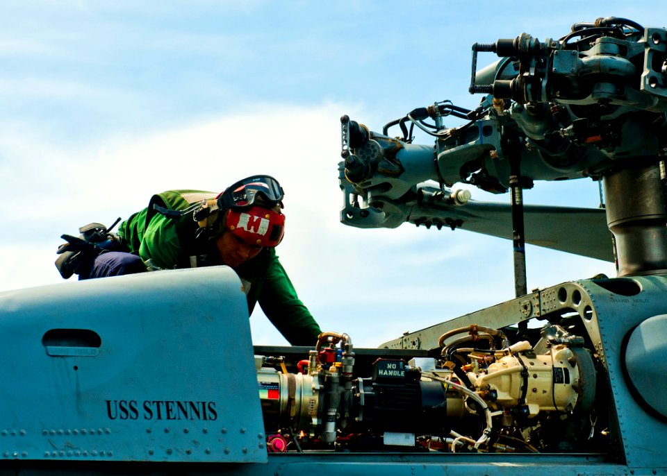 US Navy 120201-N-BT887-050 Aviation Structural Mechanic 3rd Class Makos Chhay performs a turnaround inspection on an MH-60R Sea Hawk helicopter