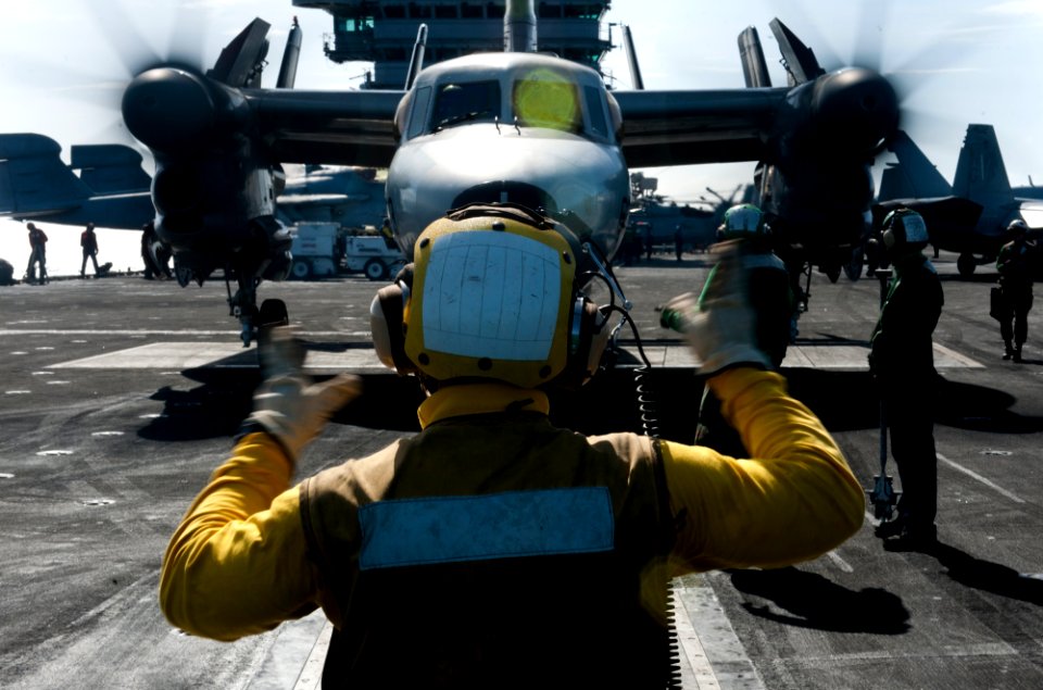 US Navy 120206-N-OY799-341 A Sailor directs a jet