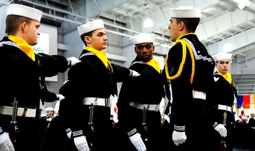 US Navy 120203-N-CD297-112 Recruits from staff division's rifle drill team participate in pass-in-review graduation ceremony in the USS Midway Cere