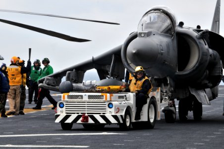 US Navy 120202-N-UM734-022 Sailors maneuvers an AV-8B Harrier on the flight deck of the amphibious assault ship USS Kearsarge (LHD 3)