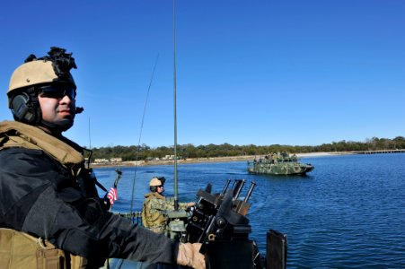 US Navy 120130-N-YX920-015 Boatswanain's Mate 2nd Class Shawn Chavez, assigned to Riverine Squadron 2, serves as a lookout while pulling away from