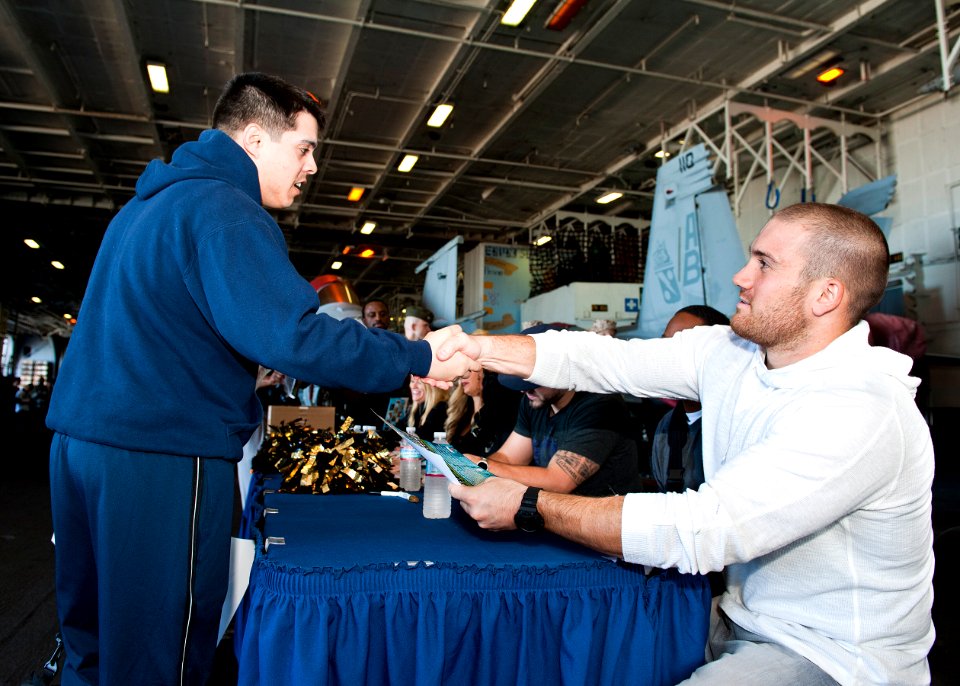 US Navy 120131-N-FI736-077 Jacksonville Jaguars players and cheerleaders sign autographs for Sailors and Marines in the hangar bay of the aircraft