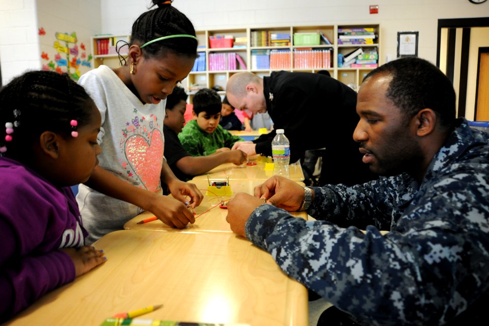 US Navy 120201-N-SF508-146 eoman 1st Class Steven Campbell, assigned to the Naval Criminal Investigative Service Office of Military Support, helps