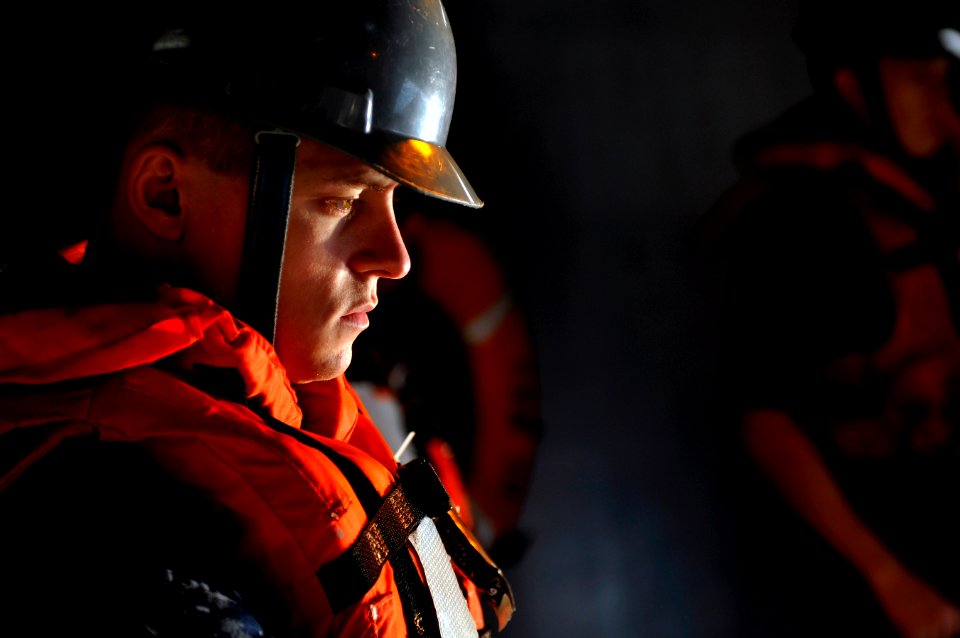 US Navy 120131-N-UT411-062 Seaman Kim Lockerby works as a line handler while launching a rigid hull inflatable boat during a man overboard drill ab