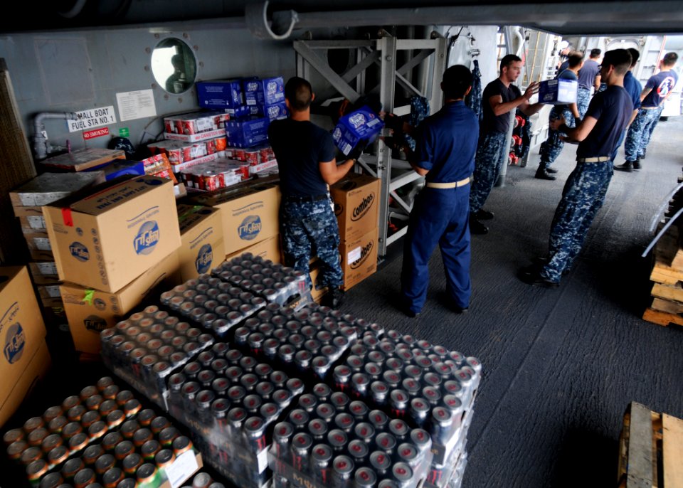 US Navy 120202-N-BC134-184 Sailors aboard the guided-missile cruiser USS Bunker Hill (CG 52) move supplies during an underway replenishment at sea