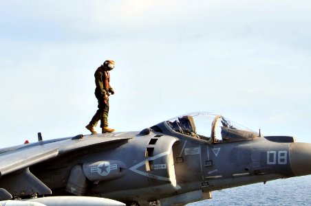 US Navy 120202-N-UM734-412 A Marine assigned to Marine Fighter Squadron (VMA) 231 inspects an AV-8B Harrier before flight operations aboard the amp