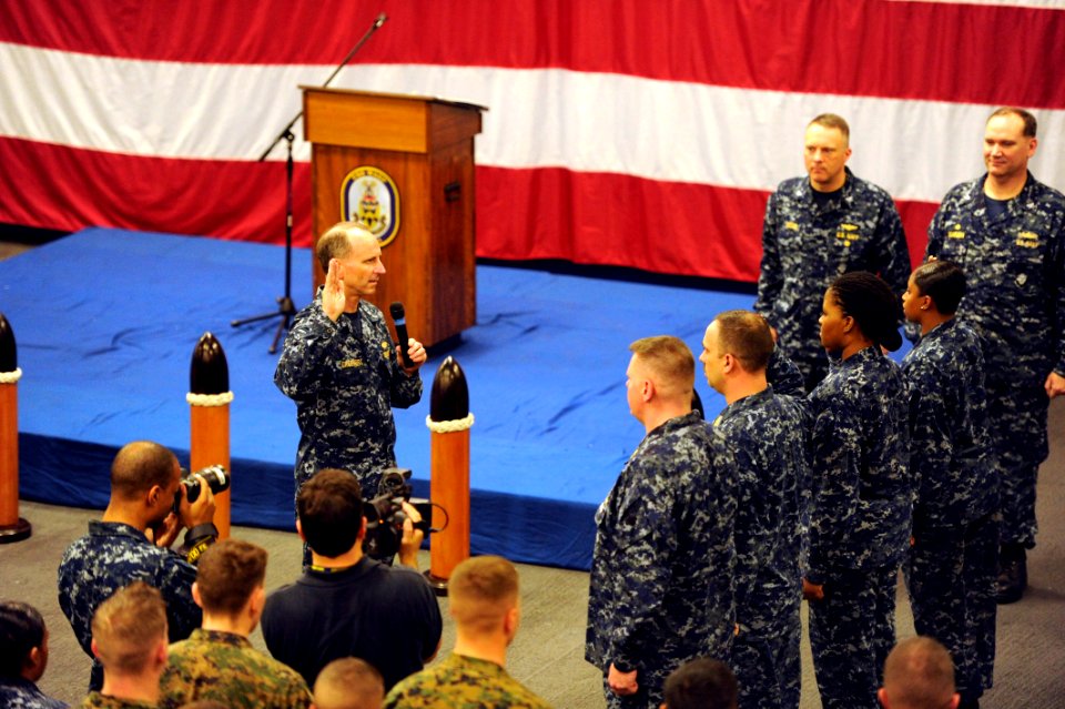 US Navy 120204-N-WL435-374 Chief of Naval Operations (CNO) Adm. Jonathan Greenert reenlists a group of Sailors the amphibious assault ship USS Wasp