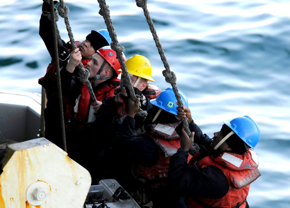 US Navy 120201-N-NU634-180 Sailors on a rigid hull inflatable boat hoist it aboard the amphibious assault ship USS Wasp (LHD 1) as part of a drill