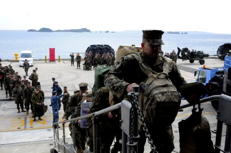 US Navy 120202-N-WV964-024 Marines assigned to the 31st Marine Expeditionary Force (MEF) climb the brow of the forward-deployed amphibious dock lan