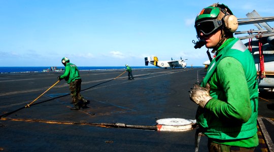 US Navy 120206-N-OY799-472 Sailors observe flight operation on the flight deck