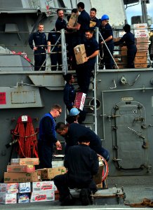 US Navy 120201-N-OP638-130 Sailors assigned to the Arleigh Burke-class guided-missile destroyer USS Porter (DDG 78) form a working party in order t