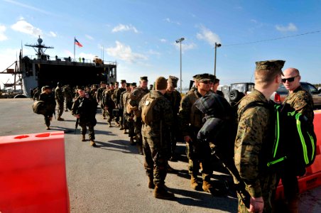US Navy 120204-N-AG285-505 Marines assigned to the 22nd Marine Expeditionary Unit (22nd MEU) depart the amphibious dock landing ship USS Whidbey Is