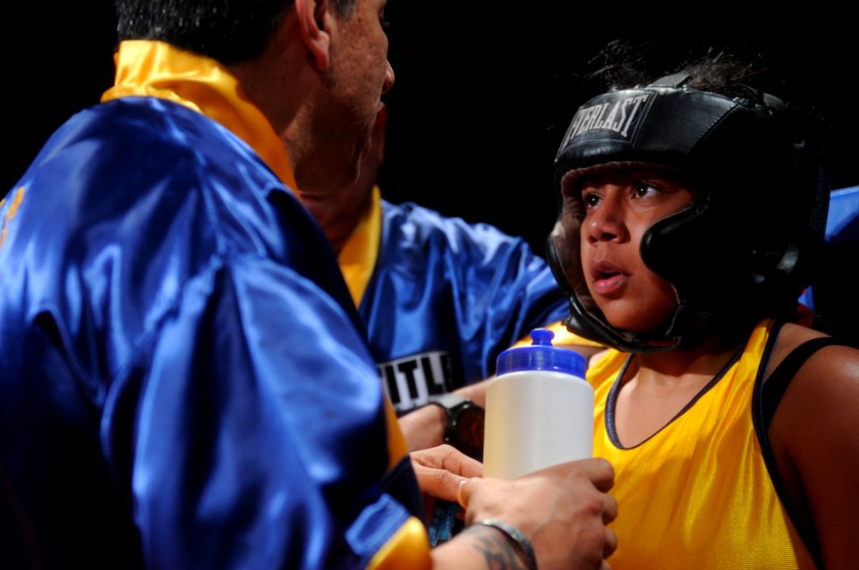 US Navy 120201-N-ZZ999-520 Navy Information Technician 2nd Class Nicole Saunders takes advice from Navy boxing coach George Sylva during her fight