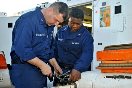 US Navy 120202-N-GO535-882 Aviation Electrician's Mate 2nd Class Christopher Proudfoot and Aviation Electronics Technician 2nd Class Vadine Chandle
