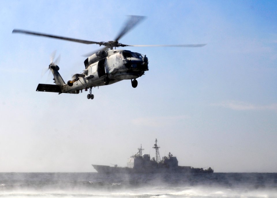 US Navy 120207-N-BC134-322 An SH-60B Sea Hawk helicopter hovers above the water during search and rescue training with the guided-missile cruiser U