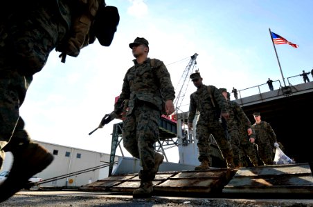 US Navy 120204-N-AG285-451 Marines assigned to the 22nd Marine Expeditionary Unit (22nd MEU) walk off the ramp of the amphibious dock landing ship