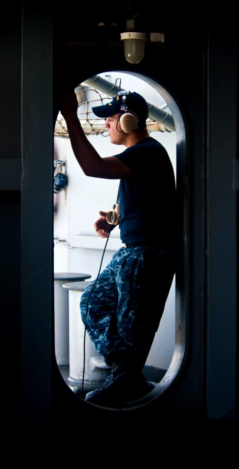 US Navy 120202-N-OY799-035 Seaman George Pulley stands lookout watch on the fantail aboard the Nimitz-class aircraft carrier USS John C. Stennis (C