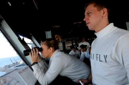 US Navy 120207-N-RG587-065 Sailors watch from primary flight control as an F-A-18C Hornet launches from the flight deck aboard the Nimitz-class air