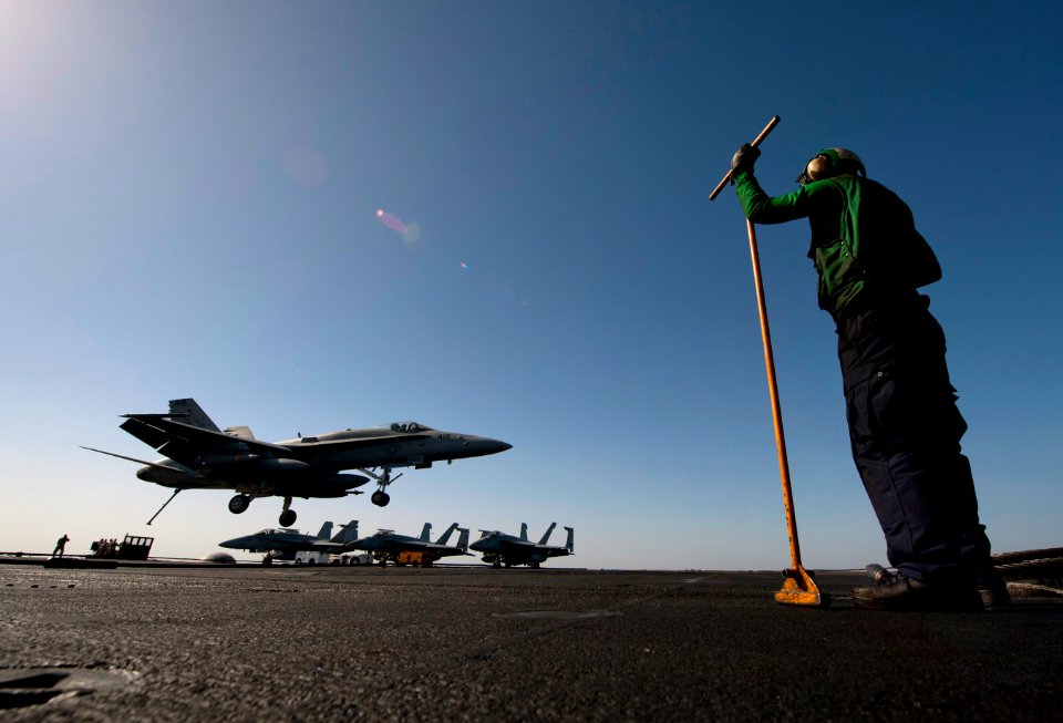 US Navy 120206-N-DR144-755 A Sailor assigned to the air department aboard the Nimitz-class aircraft carrier USS Carl Vinson (CVN 70) waits to guide