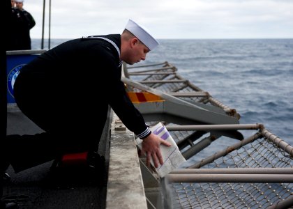 US Navy 120207-N-FI736-131 A Sailor commits cremated remains to the ocean during a burial at sea ceremony aboard the aircraft carrier USS Enterpris