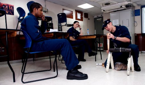 US Navy 120206-N-OY799-265 A Sailor displays how to apply a proper soft patch