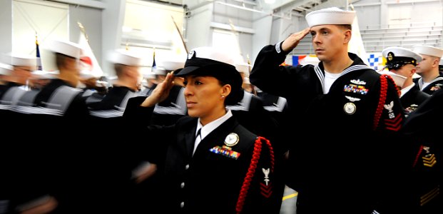 US Navy 120203-N-CD297-069 Recruit division commanders render a salute to recruits during the pass-in-review recruit graduation ceremony in the USS