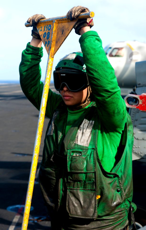 US Navy 120207-N-OY799-123 Aviation Boatswain's Mate (Equipment) Airman Brittany Wells observes aircraft recoveries on the flight deck of the Nimit