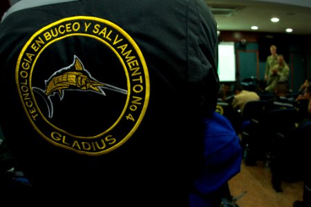 US Navy divers discuss their underwater robot with Colombian divers as part of Southern Partnership Station '14 140819-N-IP743-177