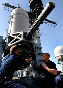 US Navy 120206-N-BC134-044 Sailors aboard the guided-missile cruiser USS Bunker Hill (CG 52) perform maintenance on a close-in weapons system