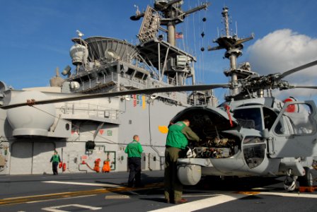 US Navy 120203-N-VG904-038 An air crewman performs pre-flight maintenance