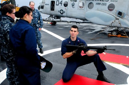 US Navy 120204-N-WV964-005 A Sailor answers questions about gun safety before a small arms shoot
