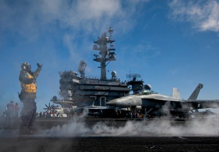 US Navy 120206-N-DR144-651 Aviation Boatswain's Mate (Handling) Emmanuel Gedeon directs aircraft onto the waist catapults