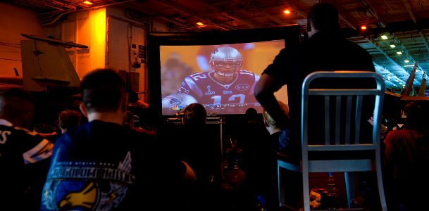 US Navy 120206-N-OY799-198 Sailors cheer on their respective teams during a Super Bowl party in hangar bay