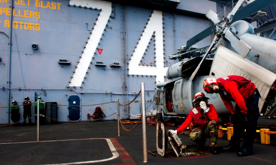 US Navy 120207-N-OY799-015 Aviation ordnancemen perform a communications check from a weapons elevator on the flight deck of the Nimitz-class aircr