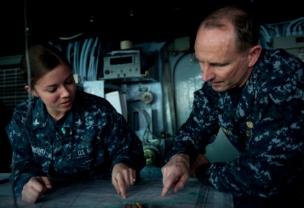US Navy 120204-N-CS815-076 Chief of Naval Operation (CNO) Jonathan Greenert and Quartermaster 3rd class Katrina Wright look over a navigation chart photo
