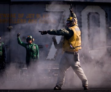 US Navy 120206-N-TZ605-356 Lt. Paul Dussault, a flight deck officer aboard the Nimitz-class aircraft carrier USS Carl Vinson (CVN 70), performs a f