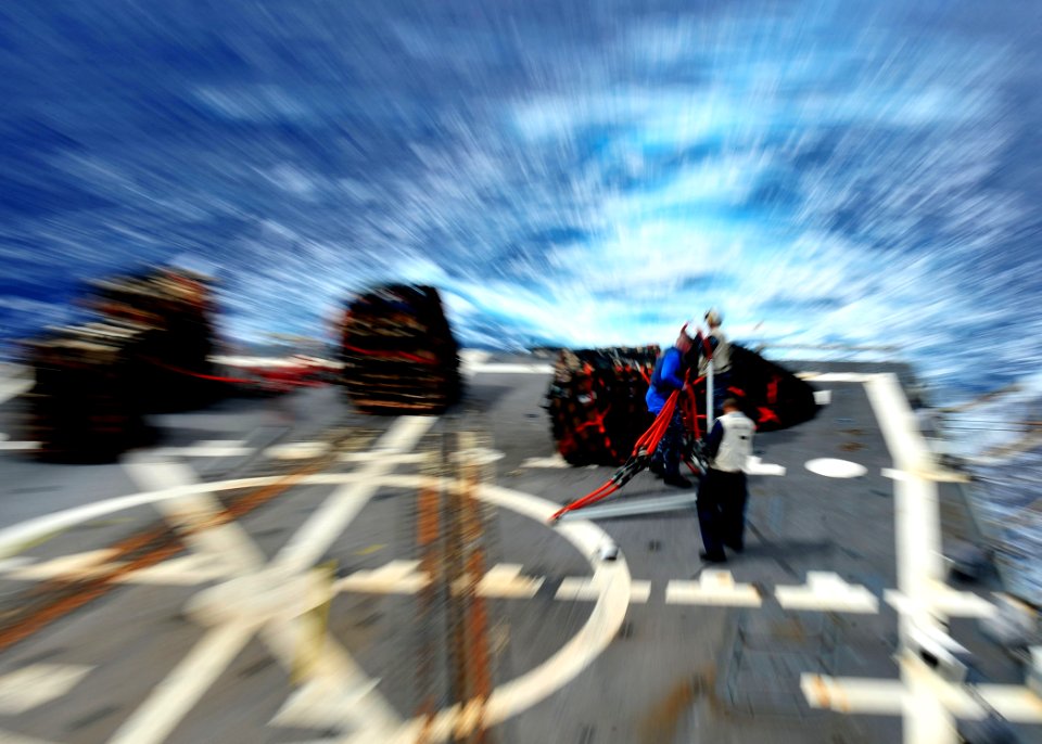 US Navy 120208-N-ED900-445 Flight deck personnel aboard the guided-missile destroyer USS Pinckney (DDG 91) prepare pallets to be lifted from the fl