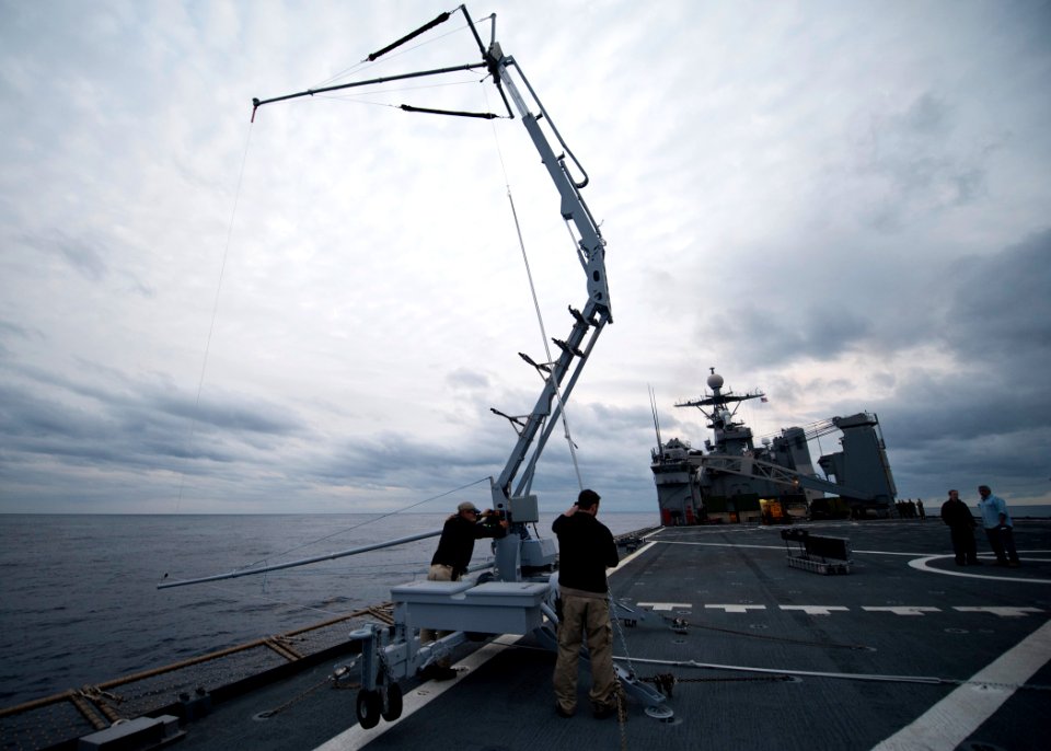 US Navy 120206-N-NR955-156 Insitu contractors prepare to recover Scan Eagle, an unmanned aerial vehicle (UAV), on the flight deck after a successf