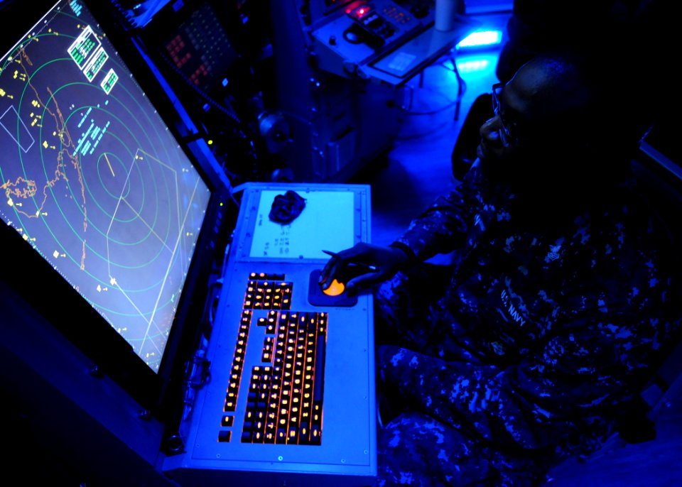 US Navy 120208-N-TU894-017 Air-Traffic Controller 1st Class Justin S. Brown tracks incoming aircraft from the carrier air traffic control center ab