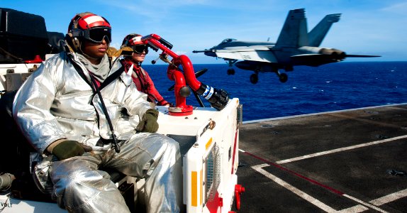 US Navy 120206-N-OY799-423 A Sailor observe as a jet launches off the flight deck