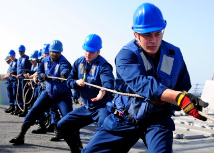 US Navy 120208-N-ZF681-088 Sailors heave a fuel line aboard the guided-missile destroyer USS Halsey (DDG 97) during a replenishment at sea with the photo